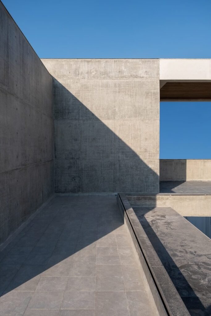 a concrete building with a sky in the background